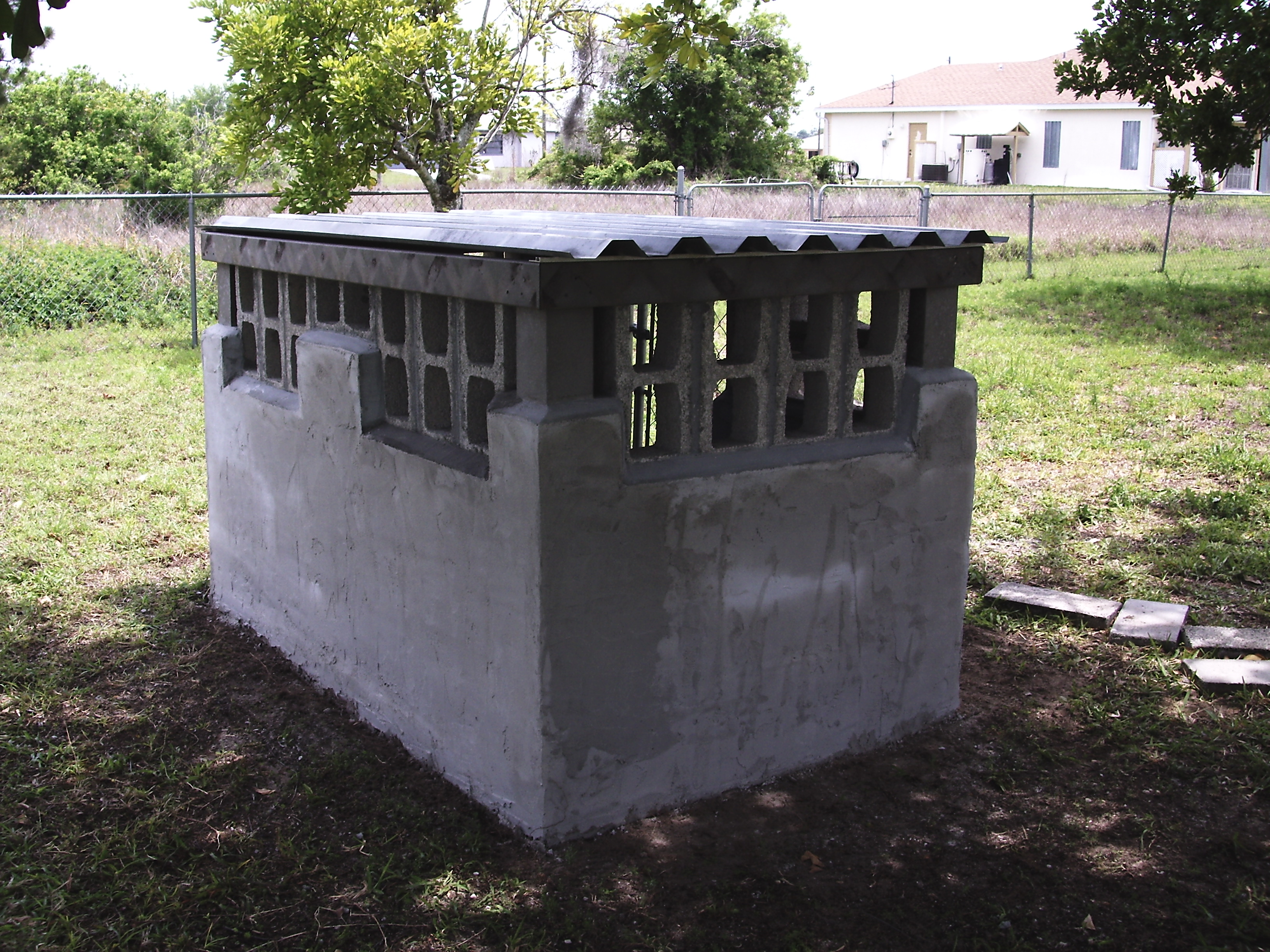 8x16 concrete block walls with locked gate and steel roof for storage 